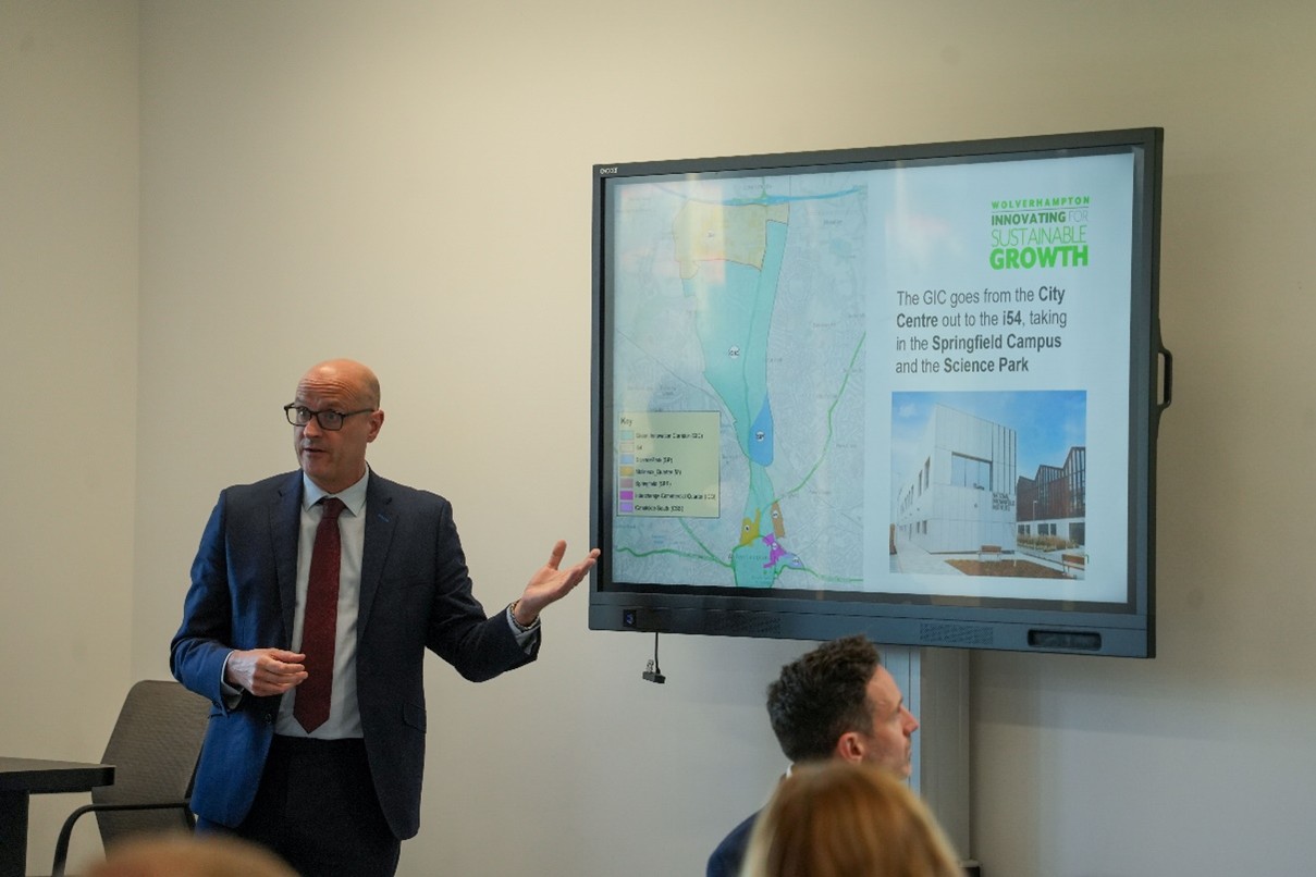 Paul Woodcock talking about the green innovation corridor with the map diagram on the board behind him.