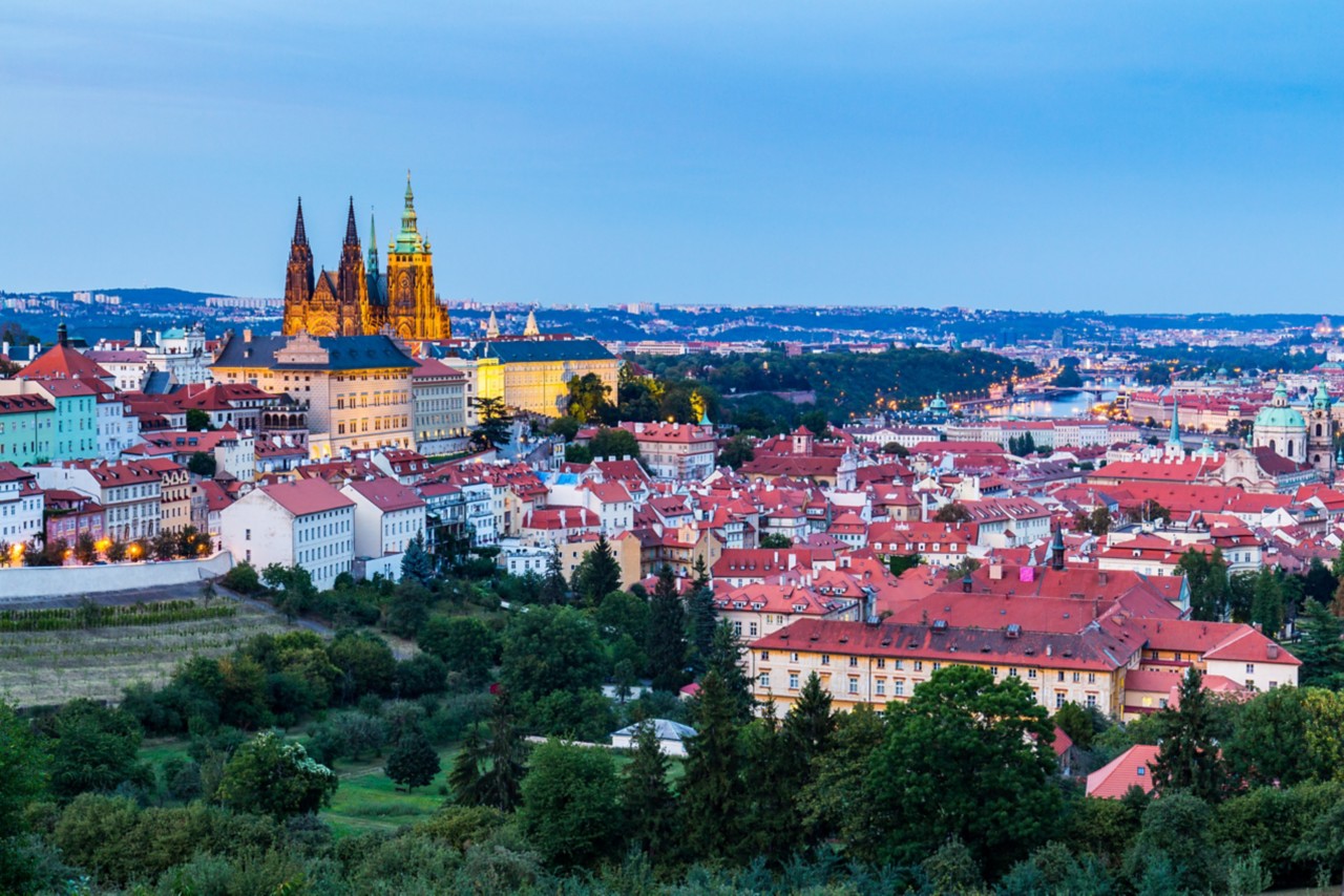Evening summer Prague panorama from Prague Hill with Prague Castle, Vltava river and historical architecture. Concept of Europe travel, sightseeing and tourism.
